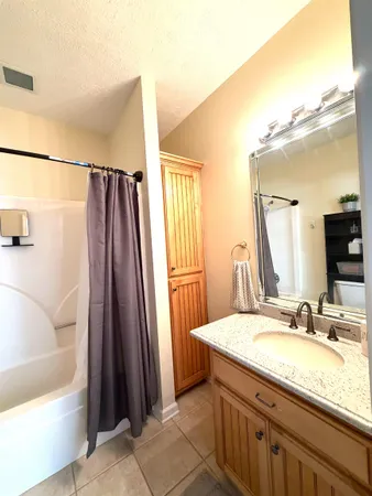 a white toilet sitting next to a bathtub