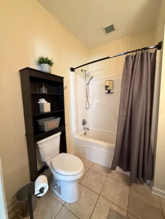 a bed room with a bed and a night stand