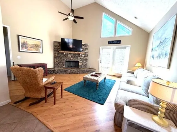 a living room with furniture fireplace and a window