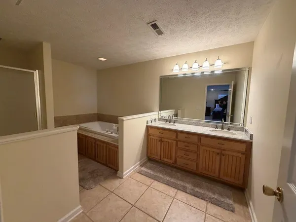 a bathroom with a tub and a shower