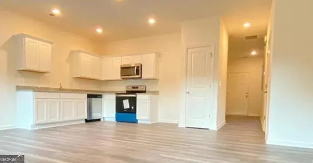 a view of a kitchen with a sink and a window