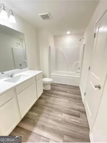 a spacious bathroom with a double vanity sink and a mirror