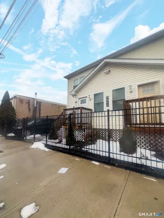 a view of a house with wooden deck front of house