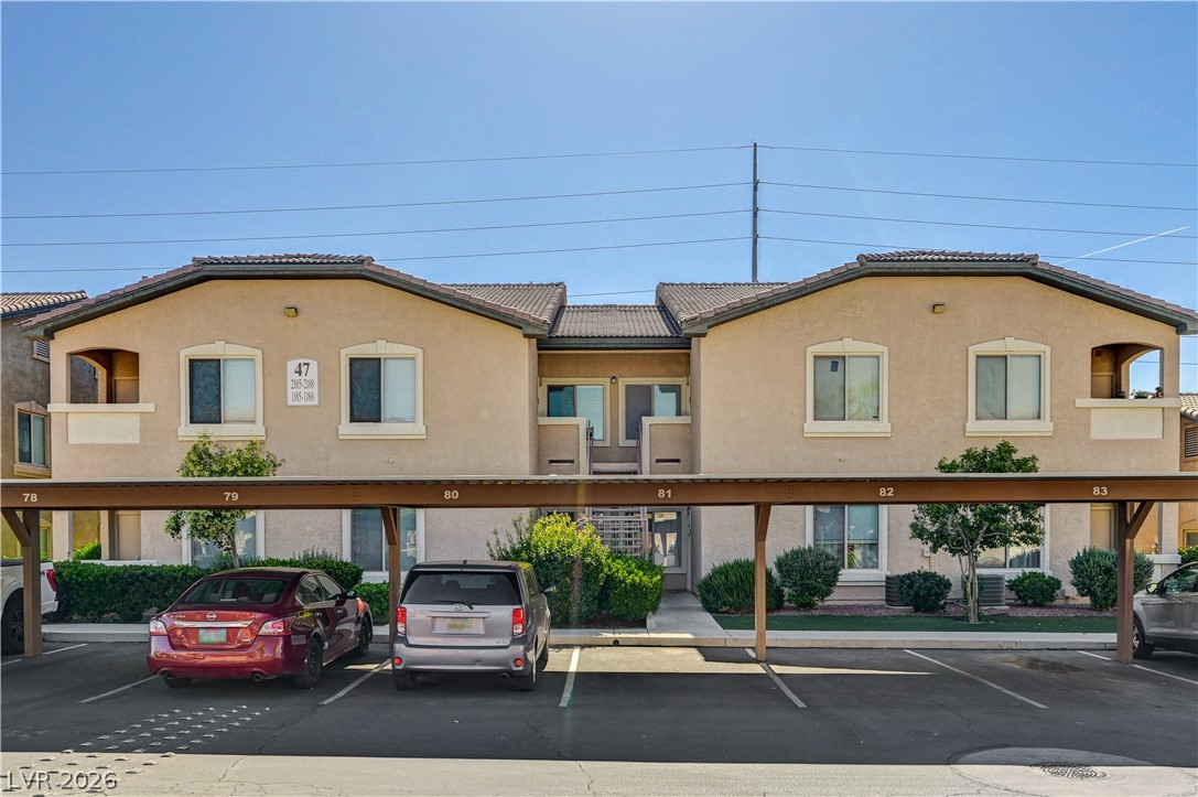 8985 South Durango Drive, Unit 2187 Las Vegas, NV 89113 - Photo 36 of 73 A welcoming multi-family dwelling with convenient covered parking beneath its tan stucco facade.