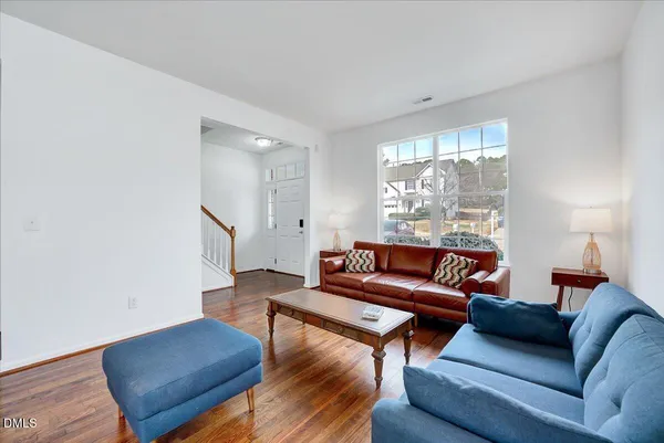a spacious bathroom with a double vanity sink a mirror and a toilet