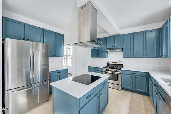 a view of a bedroom with a bed and a lamp on dresser
