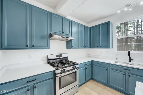 a bedroom with a bed and a tv on dresser