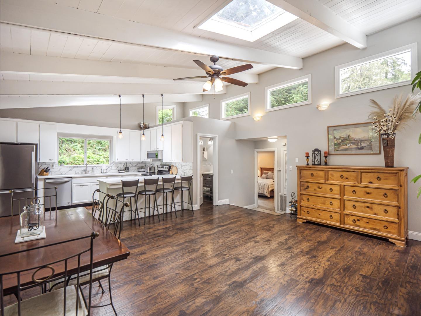 757 Cathedral Drive Aptos, CA 95003 - Photo 14 of 32 a kitchen with stainless steel appliances kitchen island granite countertop a table chairs and a refrigerator