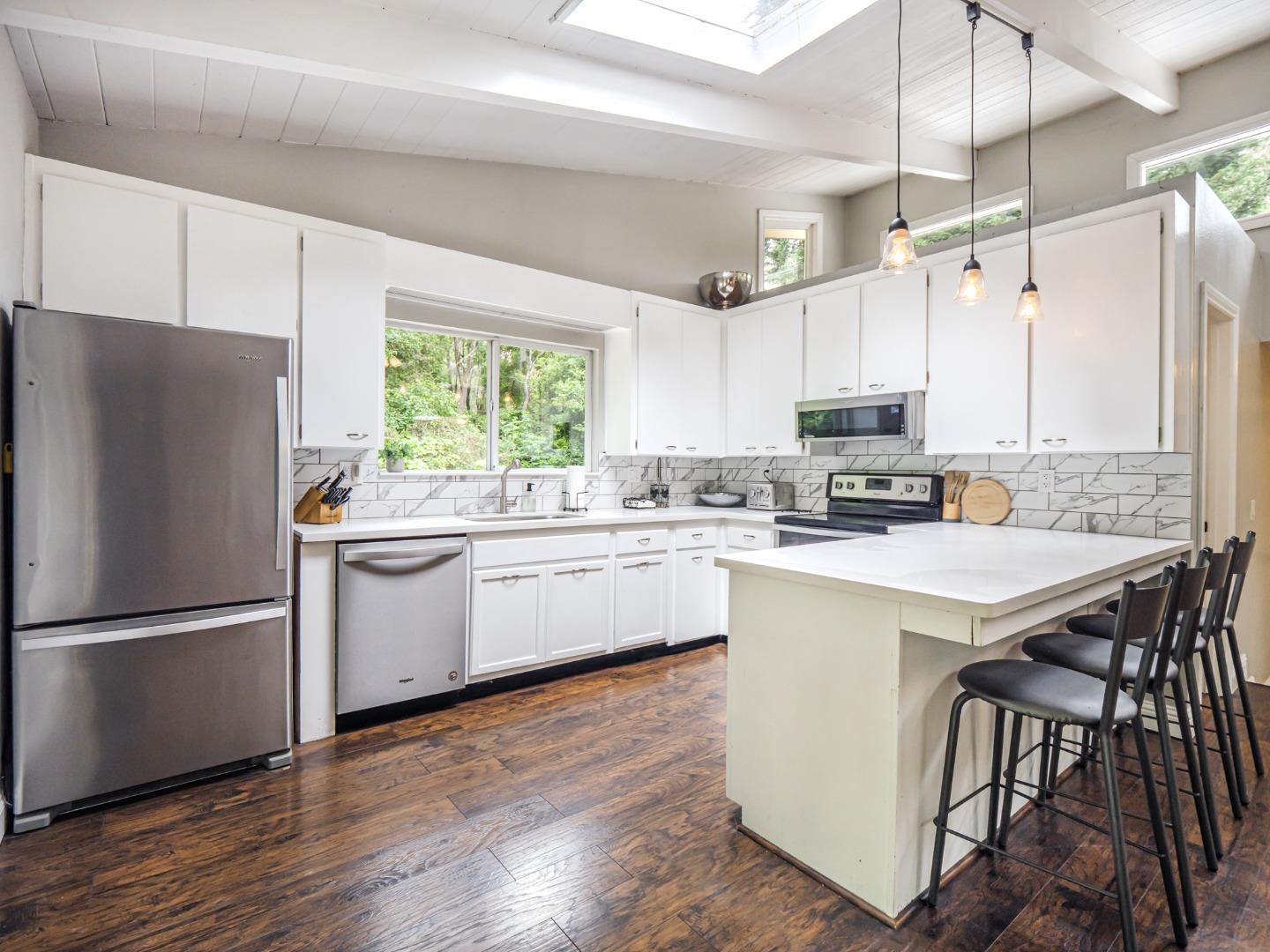 757 Cathedral Drive Aptos, CA 95003 - Photo 16 of 32 a kitchen with white cabinets and white appliances