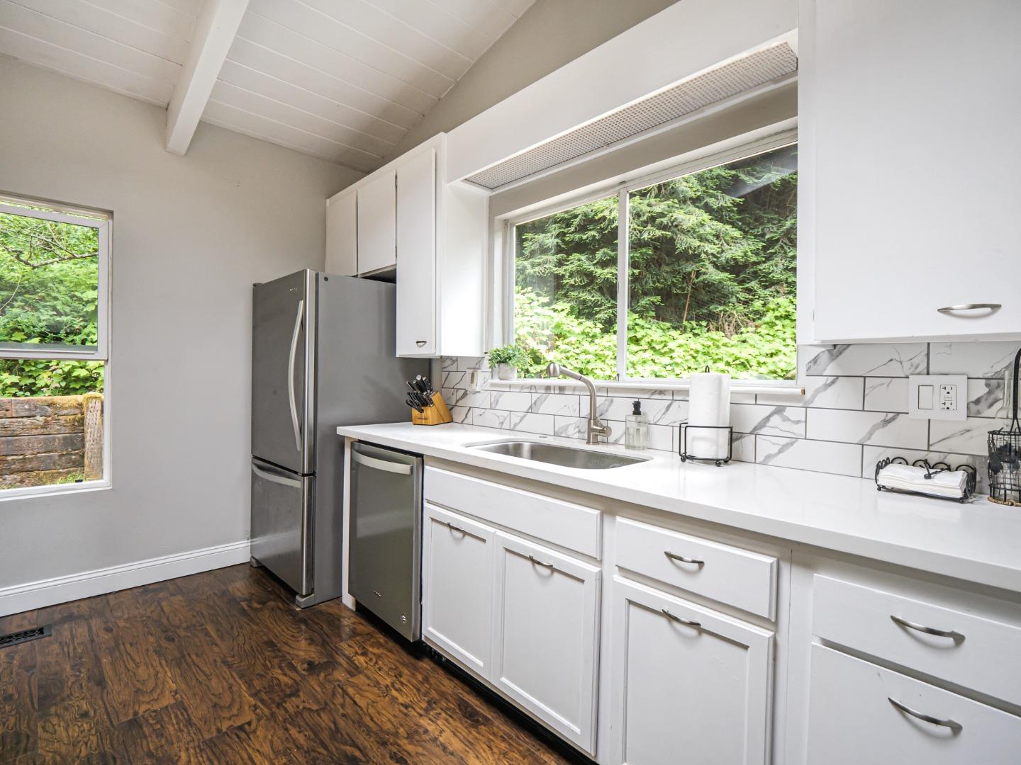757 Cathedral Drive Aptos, CA 95003 - Photo 18 of 32 a kitchen with a sink cabinets stainless steel appliances and a window