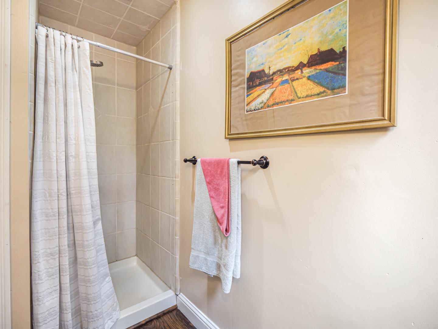 757 Cathedral Drive Aptos, CA 95003 - Photo 23 of 32 a bathroom with a shower curtain and a window