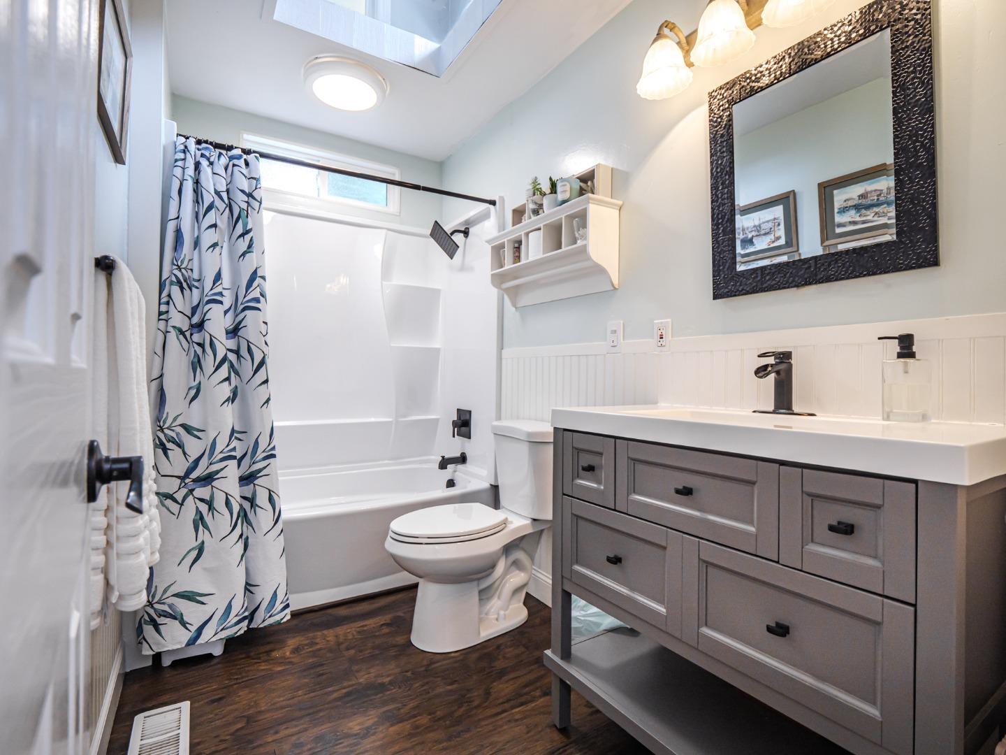 757 Cathedral Drive Aptos, CA 95003 - Photo 25 of 32 a bathroom with a sink toilet a mirror a vanity and shower