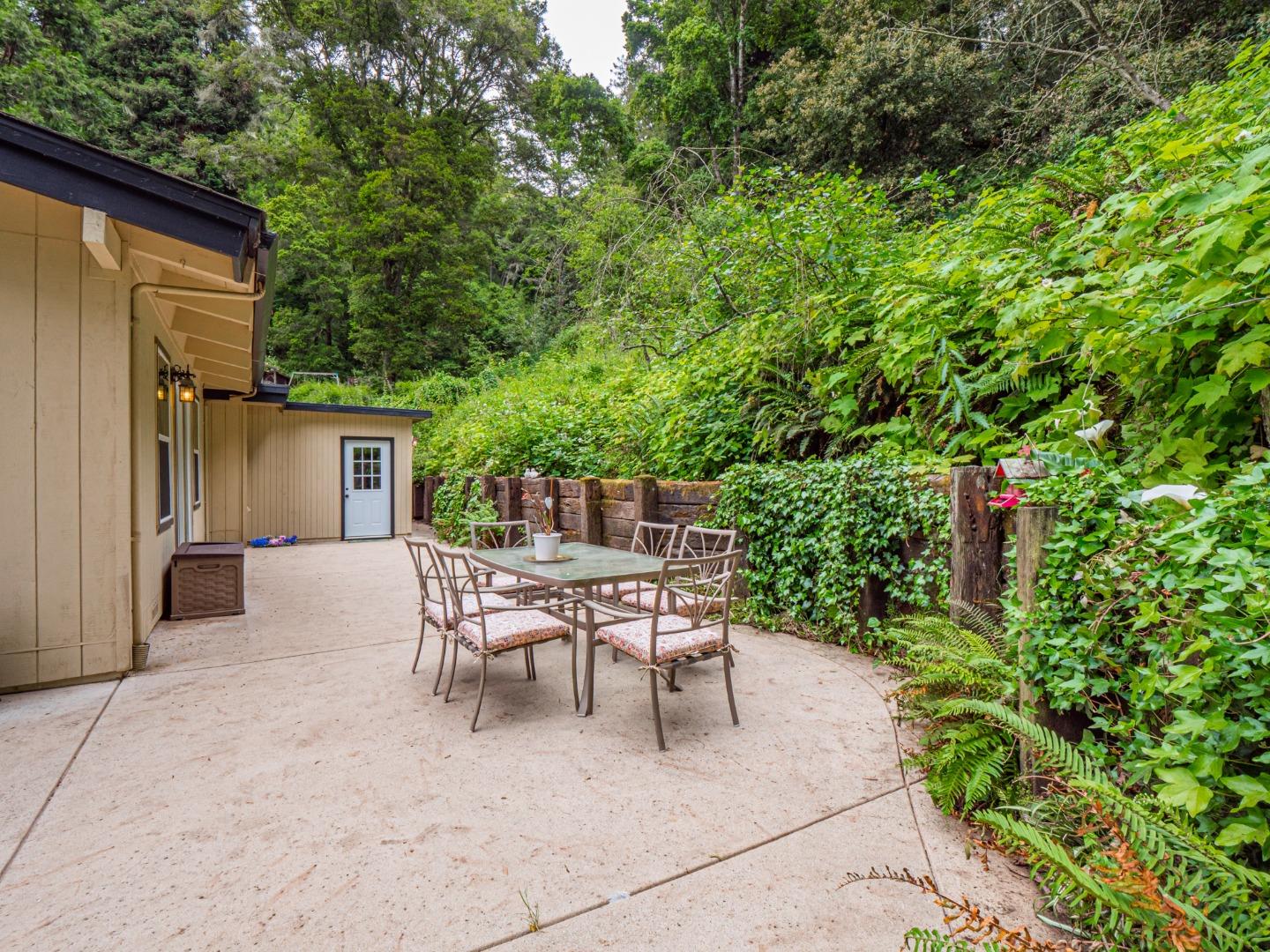757 Cathedral Drive Aptos, CA 95003 - Photo 30 of 32 a patio with table and chairs and potted plants
