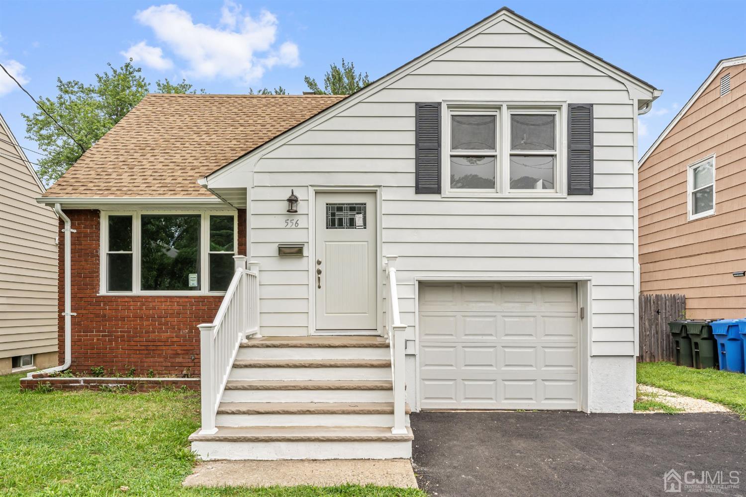 556 Chain O' Hills Road Colonia, NJ 07067 - Photo 1 of 24 a front view of a house with a yard