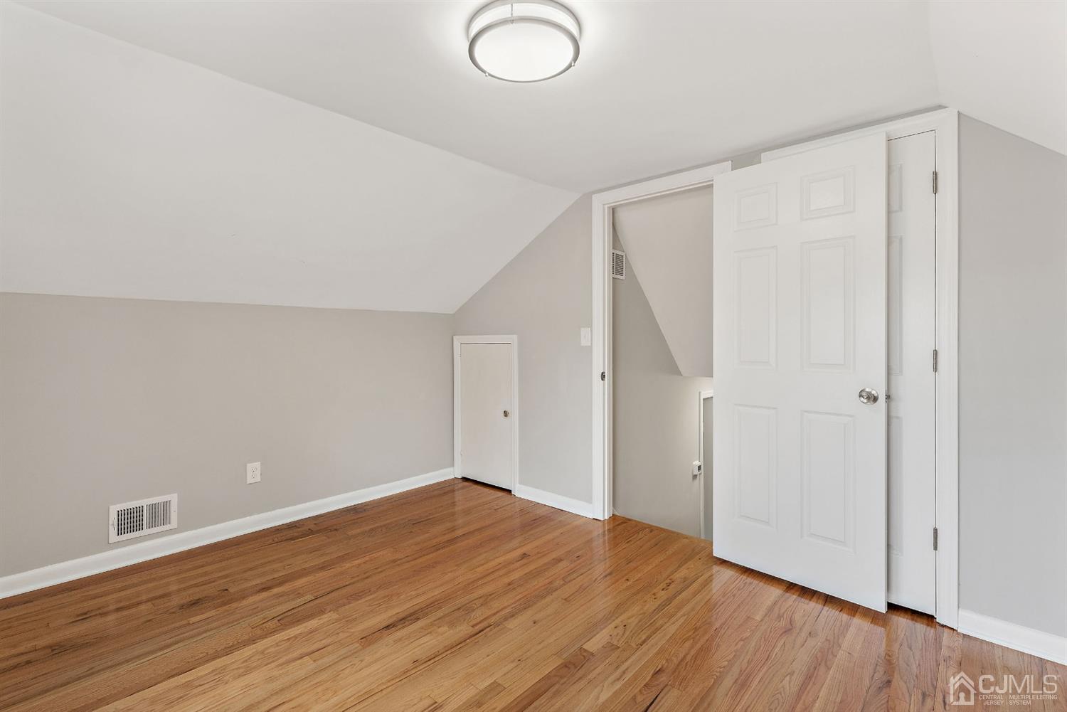 556 Chain O' Hills Road Colonia, NJ 07067 - Photo 11 of 24 a view of an empty room with wooden floor
