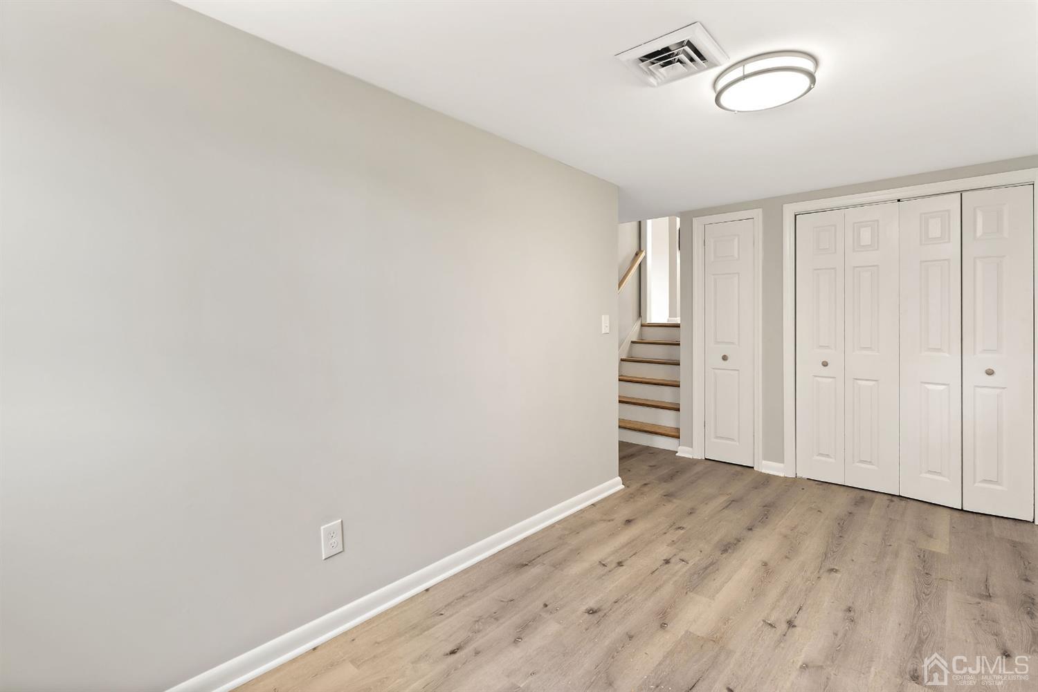 556 Chain O' Hills Road Colonia, NJ 07067 - Photo 12 of 24 an empty room with wooden floor and windows