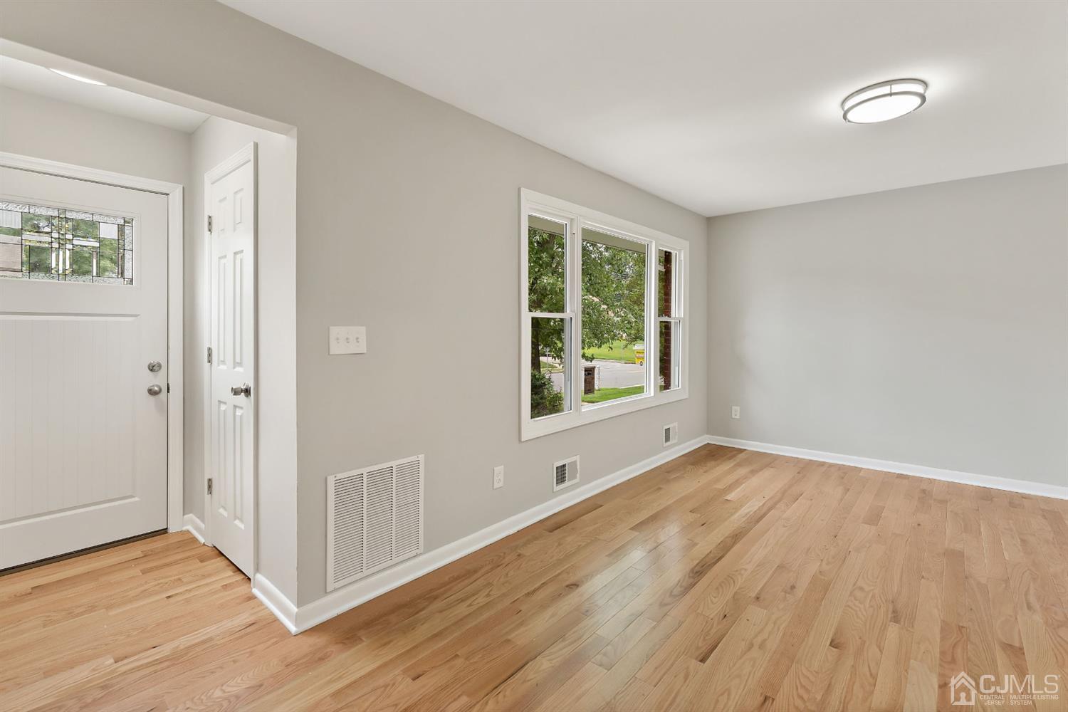 556 Chain O' Hills Road Colonia, NJ 07067 - Photo 13 of 24 an empty room with wooden floor and windows