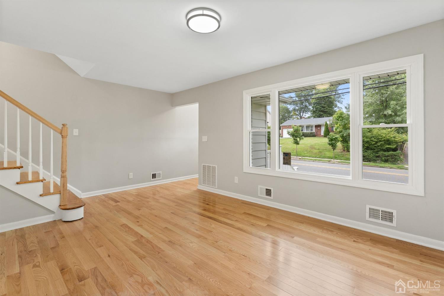 556 Chain O' Hills Road Colonia, NJ 07067 - Photo 16 of 24 a view of an empty room with wooden floor and a window