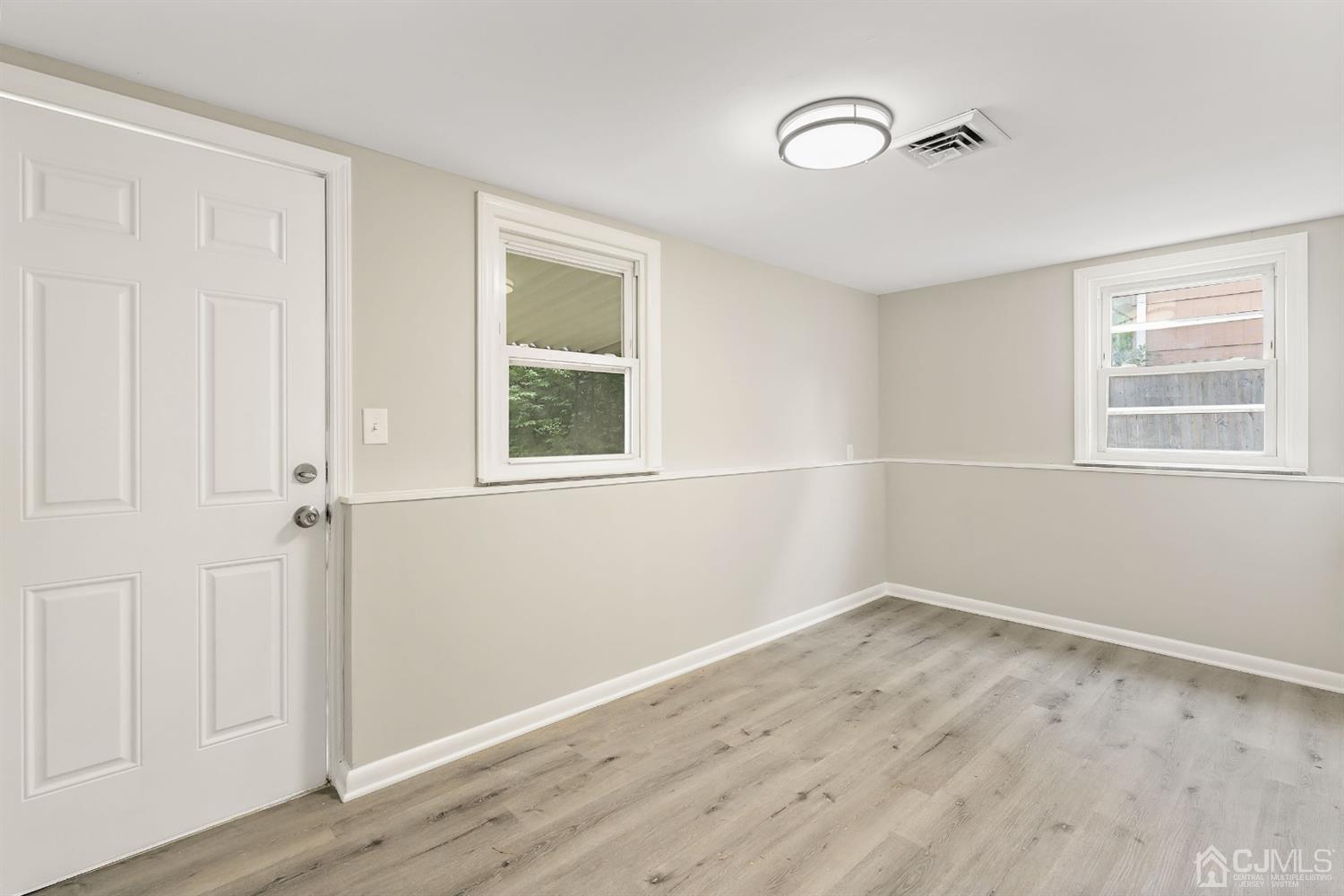 556 Chain O' Hills Road Colonia, NJ 07067 - Photo 18 of 24 a view of a room with wooden floor and windows