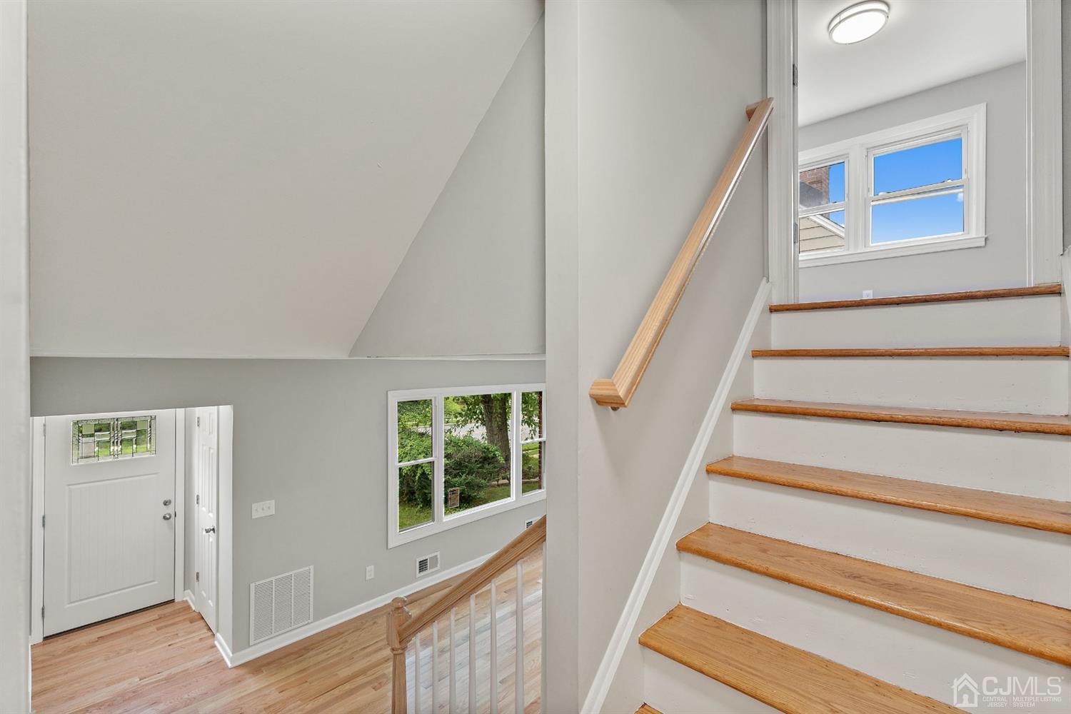 556 Chain O' Hills Road Colonia, NJ 07067 - Photo 21 of 24 a view of staircase with wooden floor and a window