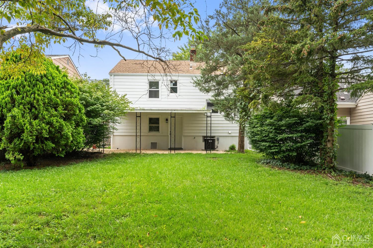 556 Chain O' Hills Road Colonia, NJ 07067 - Photo 23 of 24 a front view of a house with a garden
