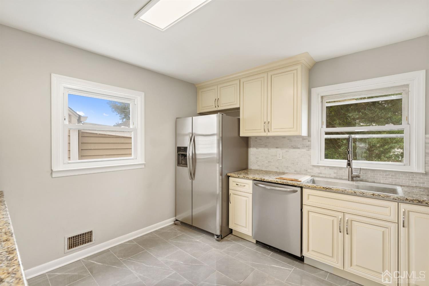 556 Chain O' Hills Road Colonia, NJ 07067 - Photo 5 of 24 a kitchen with white cabinets and white appliances