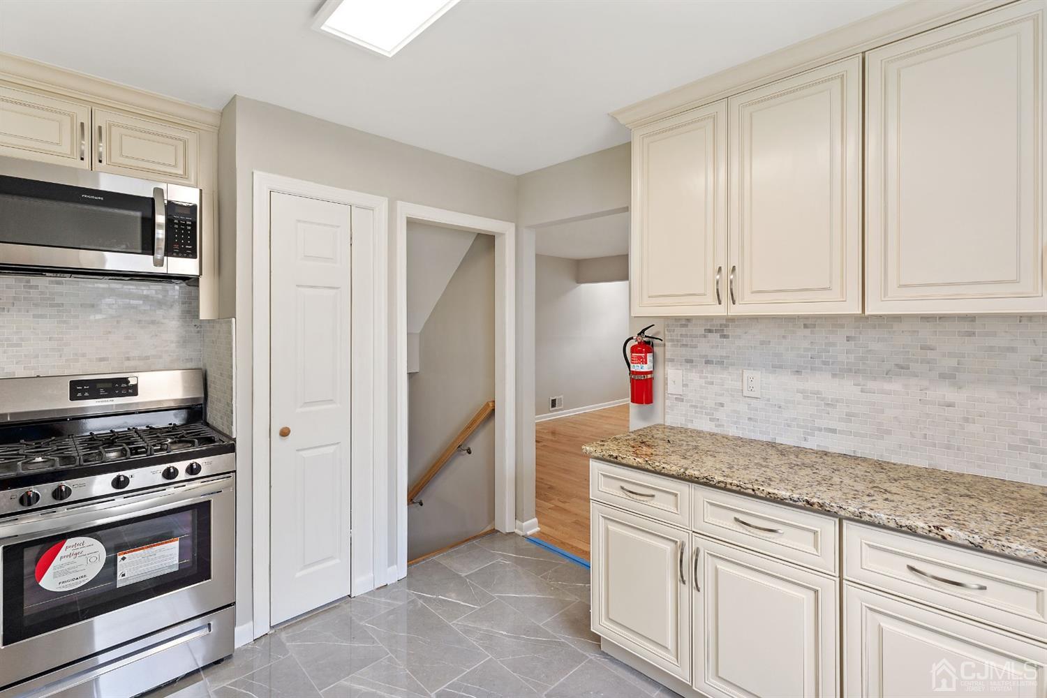 556 Chain O' Hills Road Colonia, NJ 07067 - Photo 6 of 24 a kitchen with granite countertop cabinets and steel stainless steel appliances