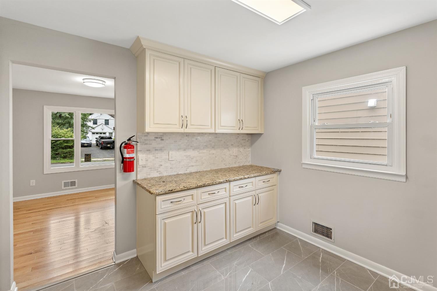 556 Chain O' Hills Road Colonia, NJ 07067 - Photo 7 of 24 a kitchen with granite countertop a sink cabinets and window
