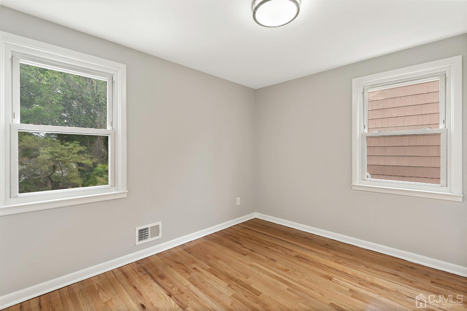 556 Chain O' Hills Road Colonia, NJ 07067 - Photo 8 of 24 a view of empty room with wooden floor and fan