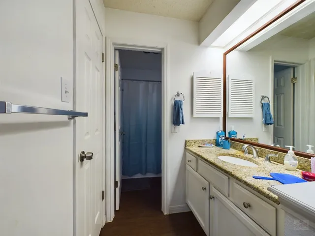 a white toilet sitting next to a bathroom sink