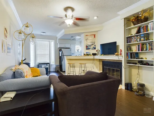a living room with furniture a fireplace and a flat screen tv
