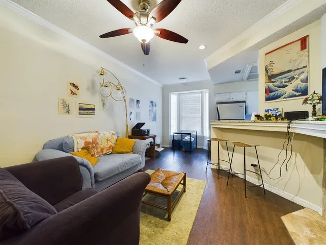 a view of a balcony with chairs and wooden fence