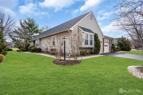 a front view of house with a garden and patio