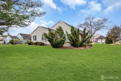 a view of a house with a big yard and potted plants