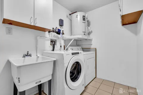 a utility room with sink dryer and washer