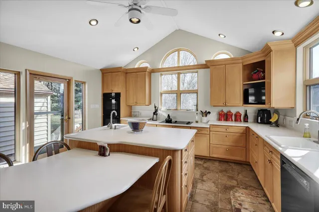 a large kitchen with kitchen island a large window