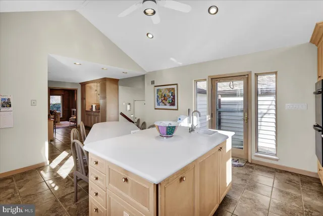 a view of kitchen island a sink and living room