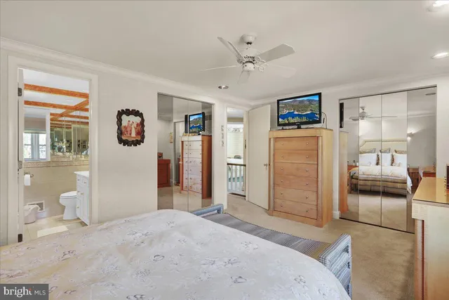 a bedroom with a bed and a view of living room