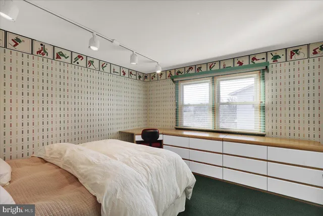 a bedroom with a bed and a large window