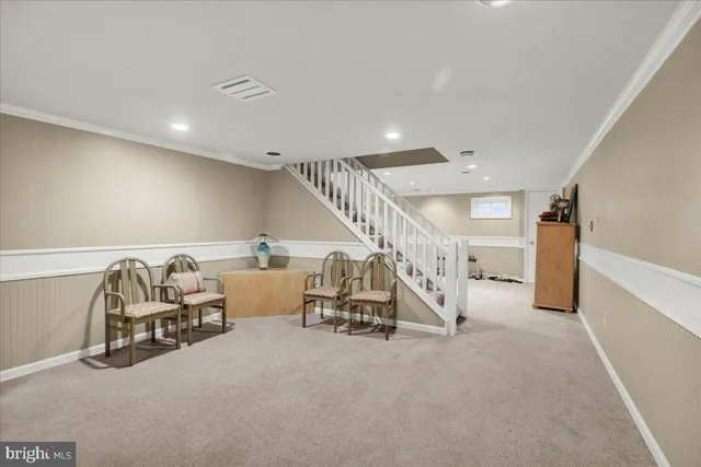 a bedroom with furniture and a flat screen tv