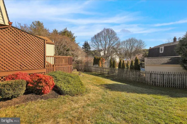 a wooden bench sitting in the middle of a yard
