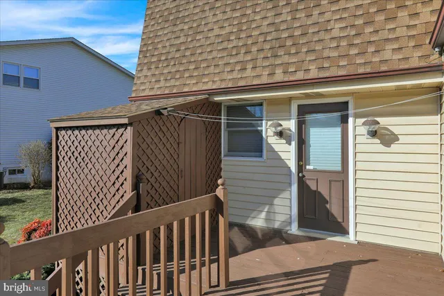 a view of a balcony with wooden floor and fence
