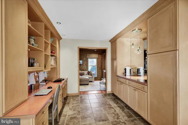 a large white kitchen with stainless steel appliances a refrigerator and a stove