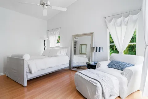 a bedroom with a bed and a large window