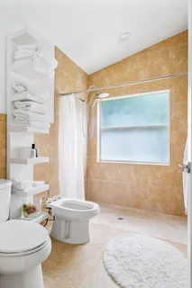 a bathroom with a toilet a sink and a shower