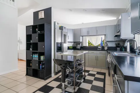 a kitchen with a refrigerator a sink and cabinets