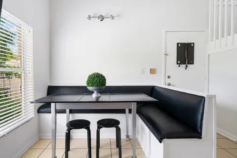 a dining room with furniture and window