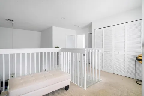 a view of a bedroom with wooden floor