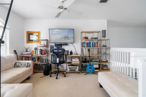 a view of a livingroom with workspace and a couch