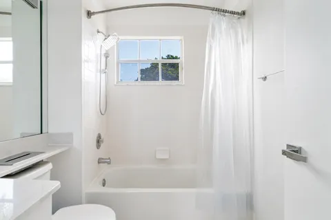 a bathroom with a bathtub and a shower